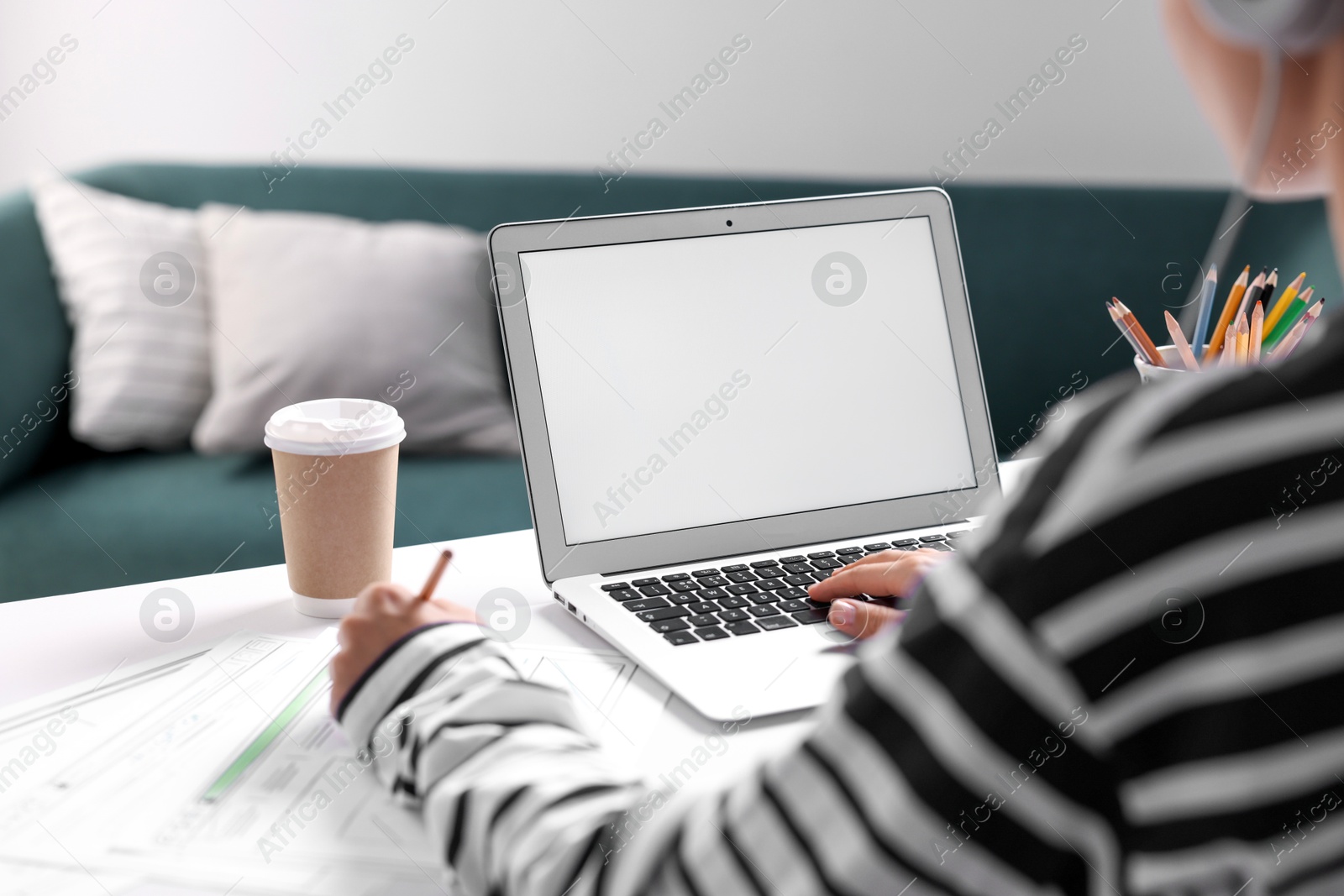 Photo of Woman working at table with laptop in office, closeup. Mockup for design