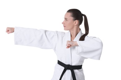 Photo of Young woman in kimono practicing karate on white background