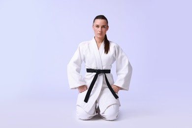 Photo of Karate fighter in kimono on light background