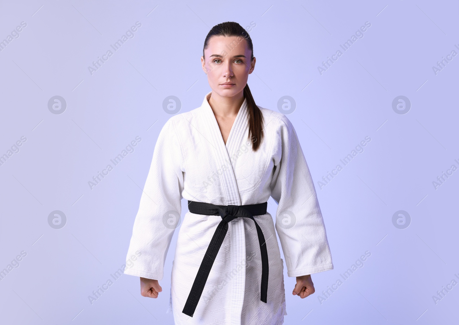 Photo of Karate fighter in kimono on light background