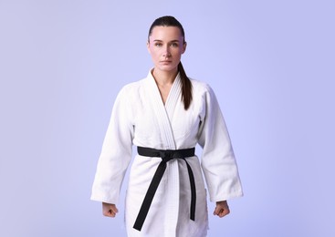 Photo of Karate fighter in kimono on light background