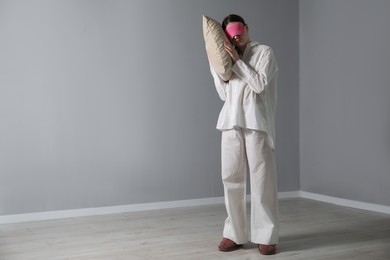 Photo of Young woman suffering from sleepwalking at home, space for text