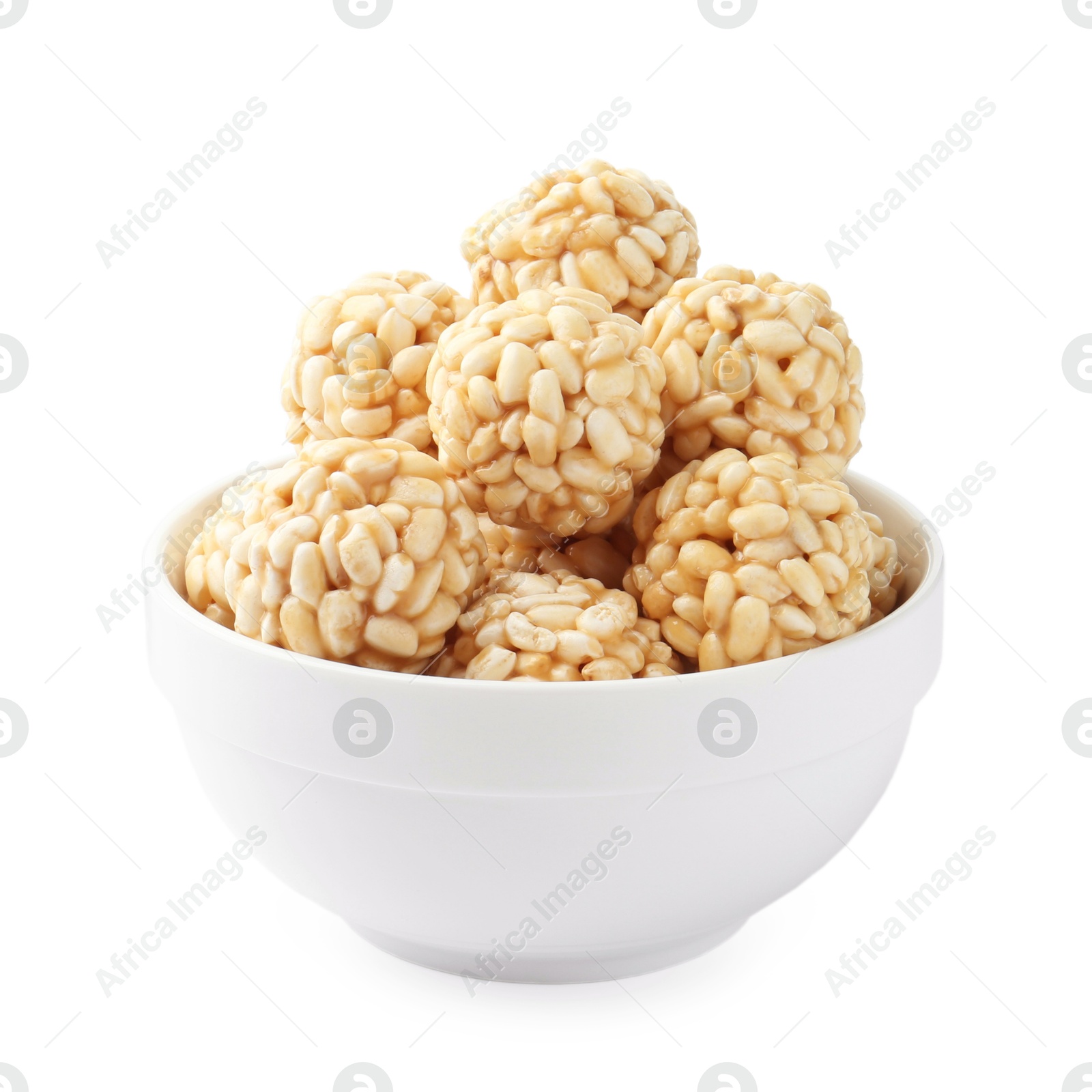 Photo of Delicious puffed rice balls in bowl isolated on white