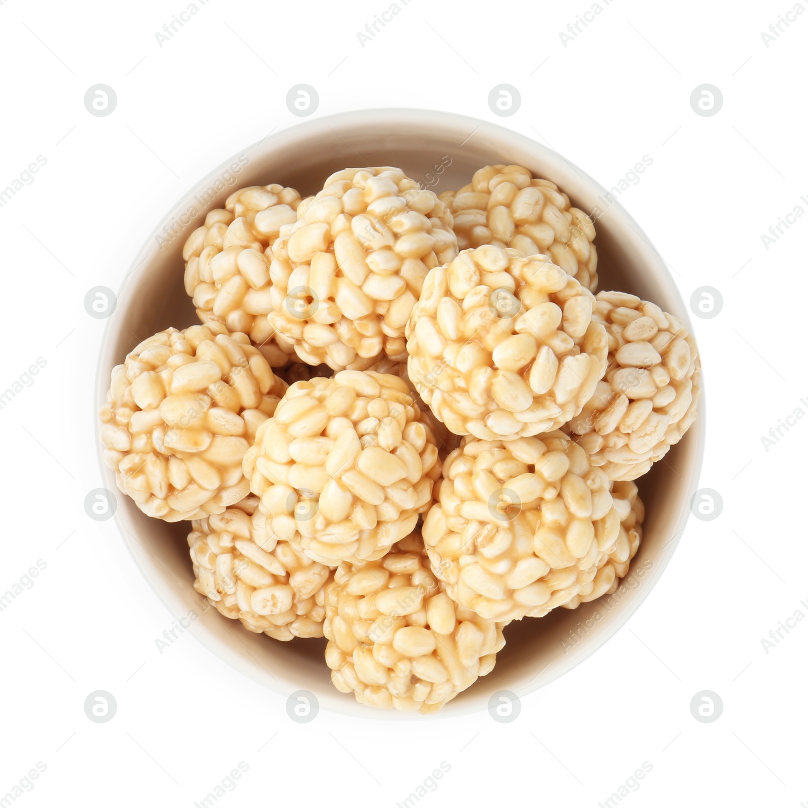 Photo of Delicious puffed rice balls in bowl isolated on white, top view