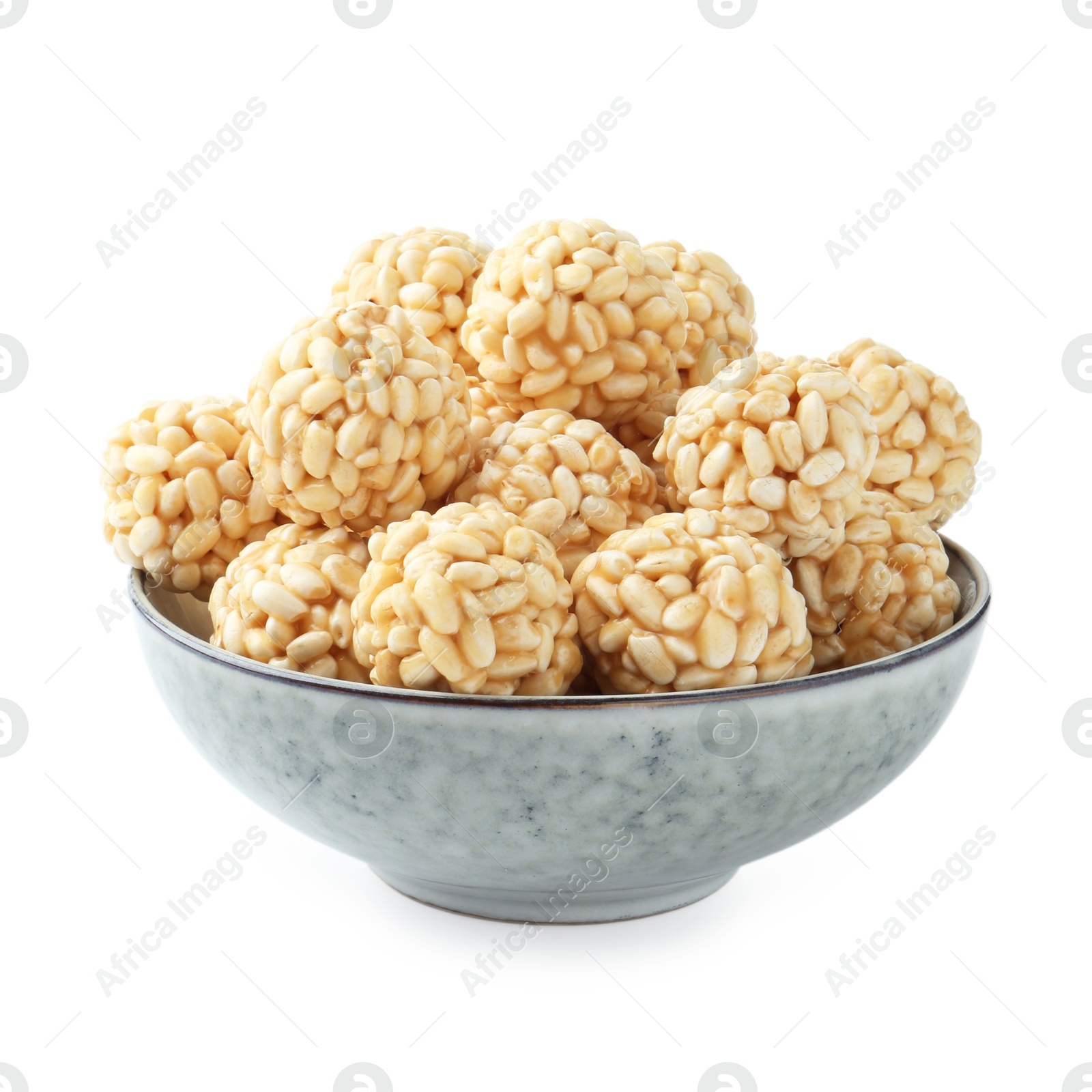 Photo of Delicious puffed rice balls in bowl isolated on white