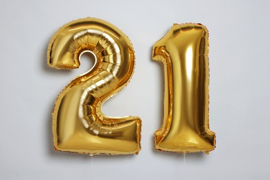 Photo of Coming of age party - 21st birthday. Number shaped balloons on light grey background