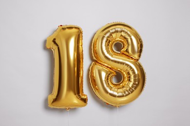 Photo of Coming of age party - 18th birthday. Number shaped balloons on light grey background