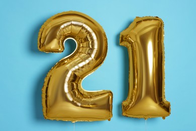 Photo of Coming of age party - 21st birthday. Number shaped balloons on light blue background