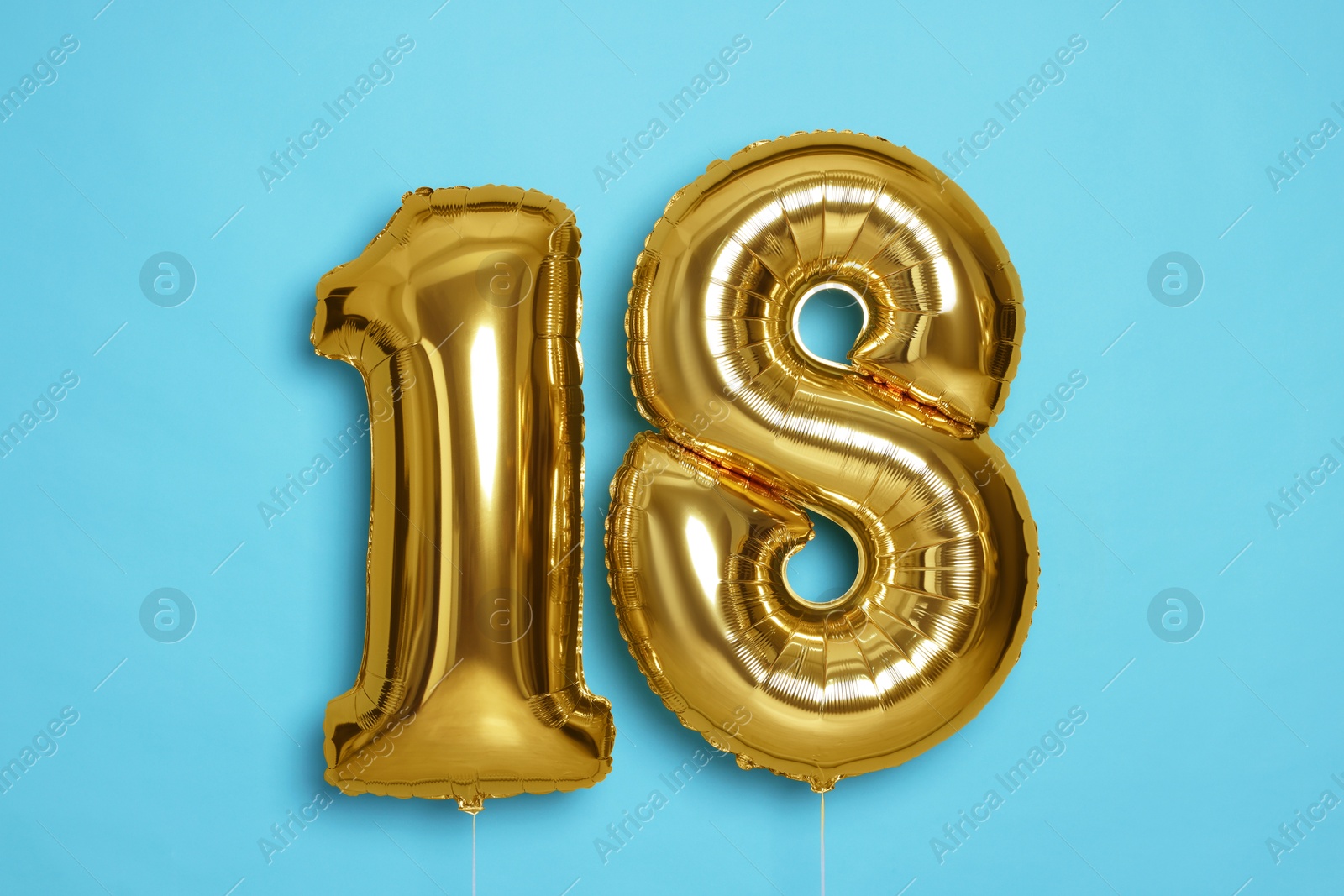 Photo of Coming of age party - 18th birthday. Number shaped balloons on light blue background