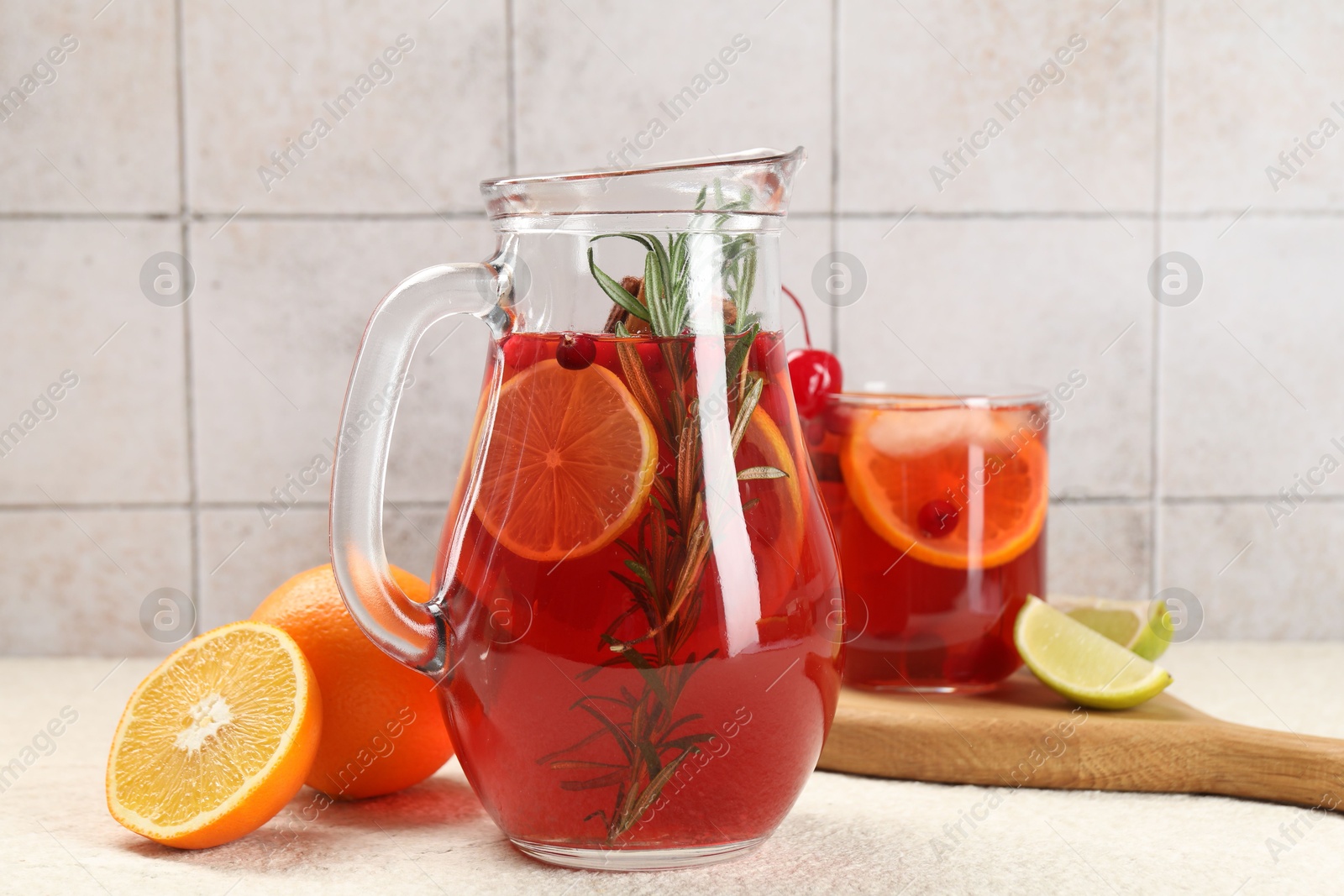 Photo of Delicious punch and ingredients on light table