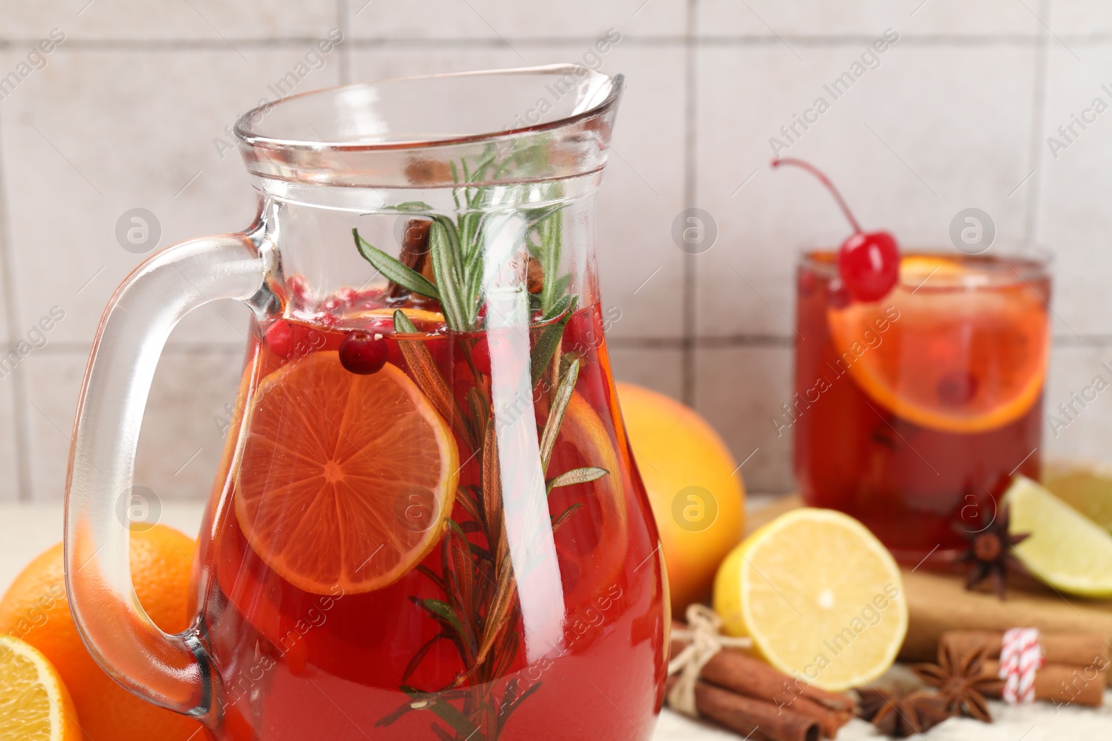 Photo of Delicious punch and ingredients on light table, closeup