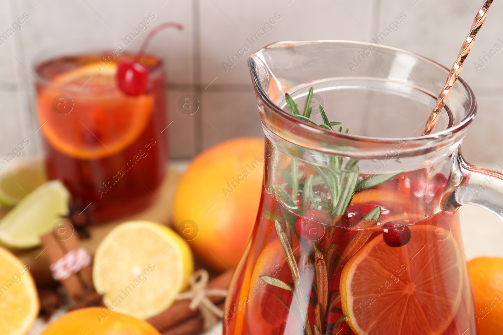 Photo of Delicious punch with rosemary in jug, closeup