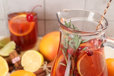 Photo of Delicious punch with rosemary in jug, closeup