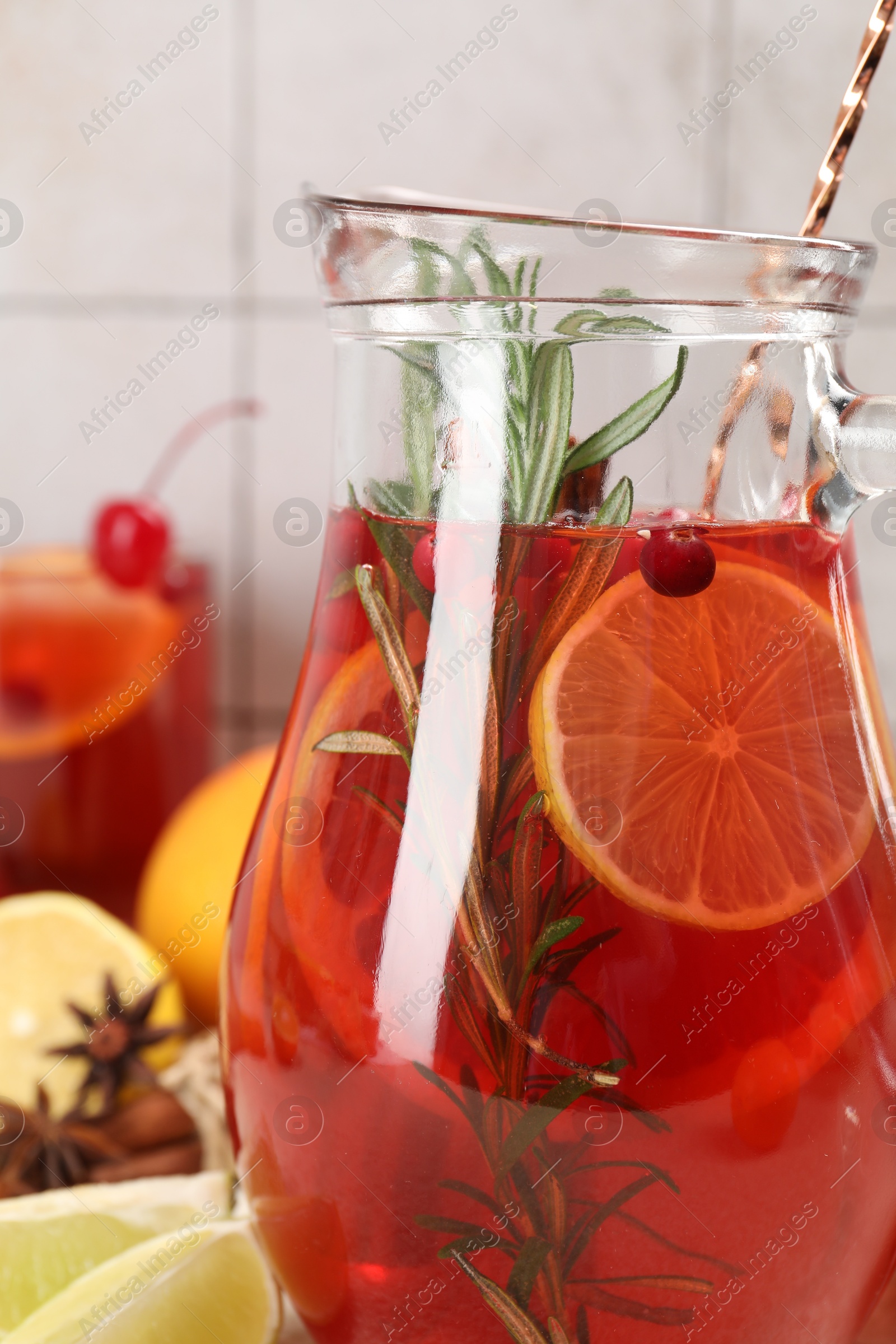 Photo of Delicious punch with rosemary in jug, closeup