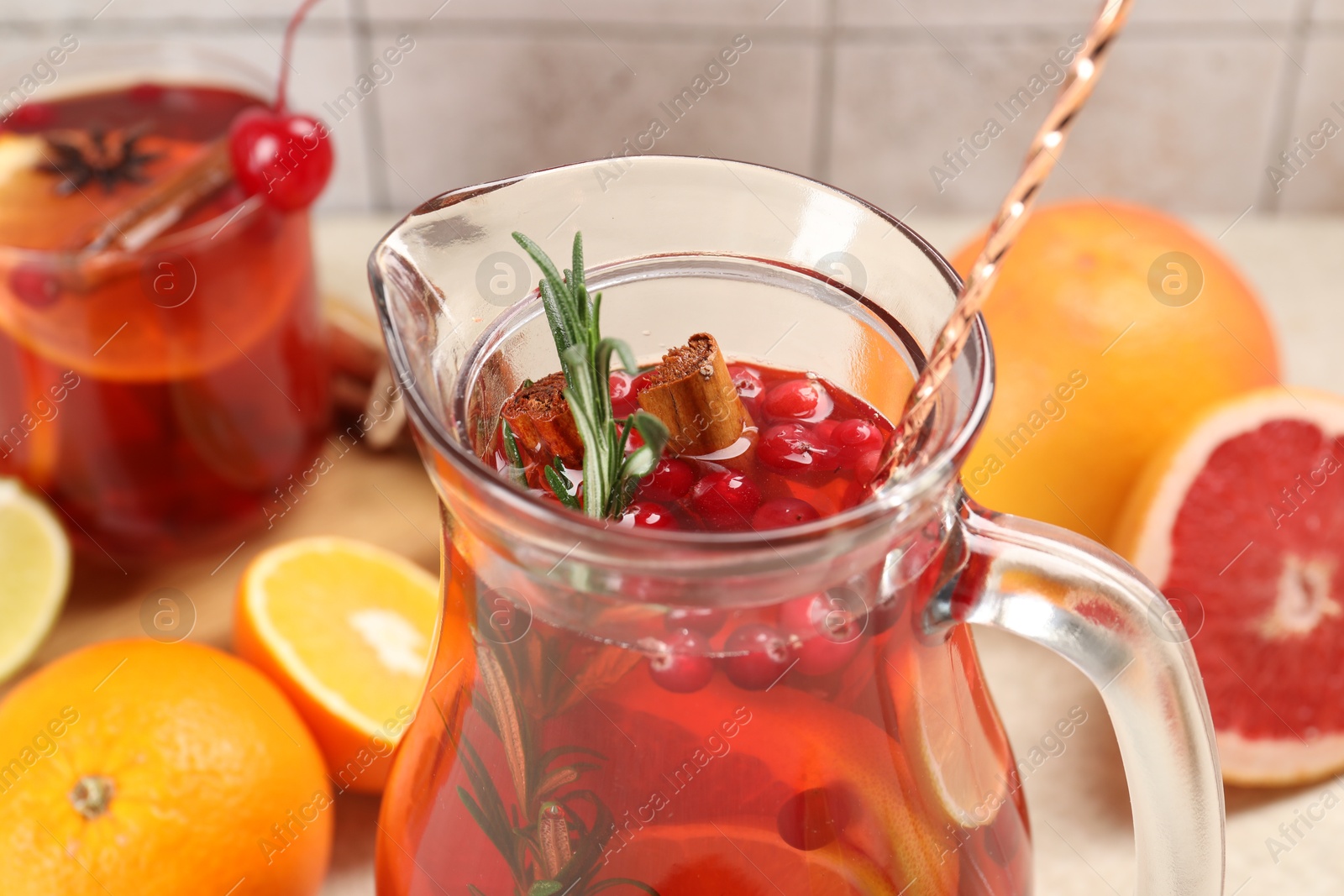 Photo of Delicious punch with rosemary in jug, closeup