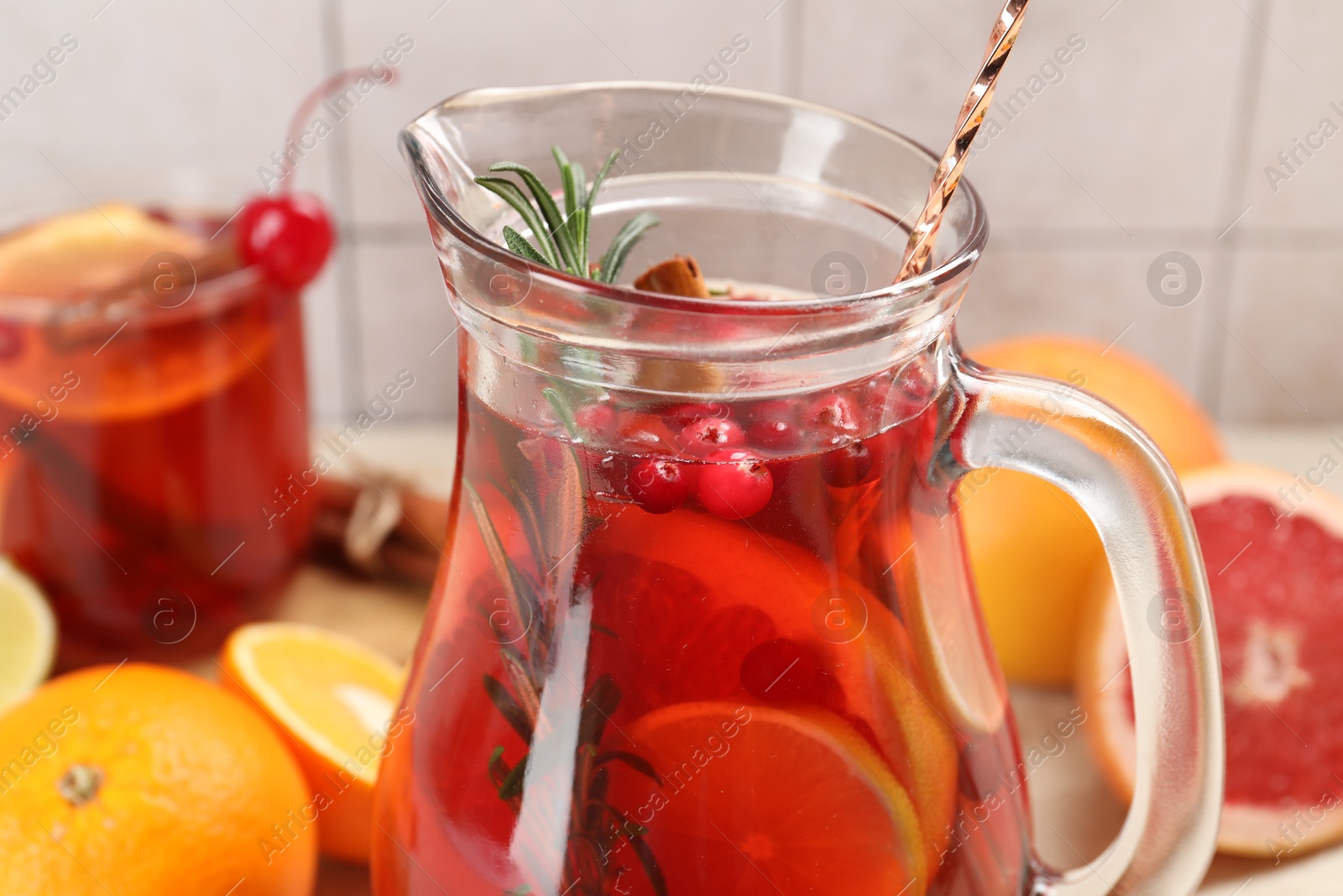 Photo of Delicious punch with rosemary in jug, closeup