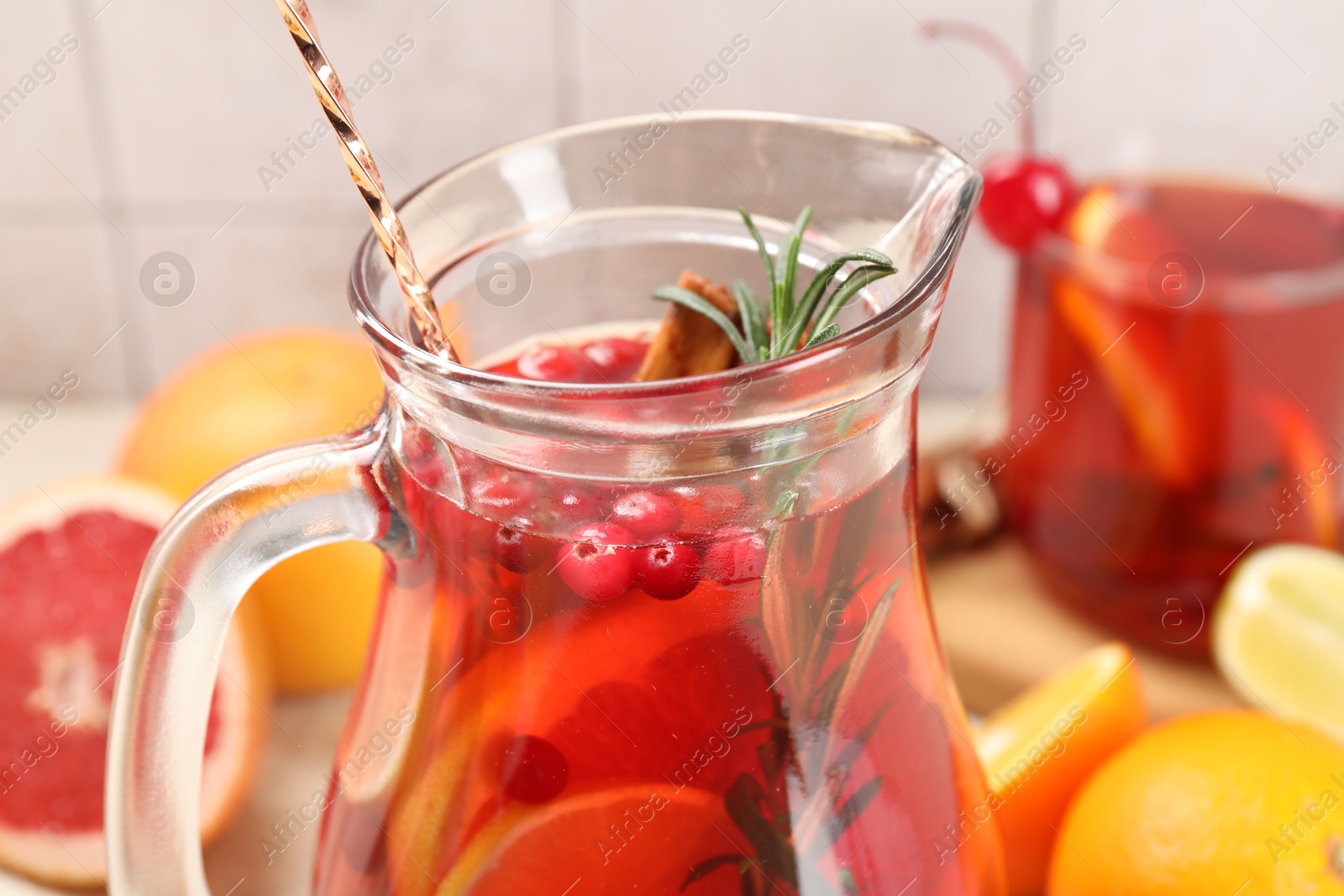 Photo of Delicious punch with rosemary in jug, closeup