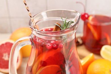 Photo of Delicious punch with rosemary in jug, closeup