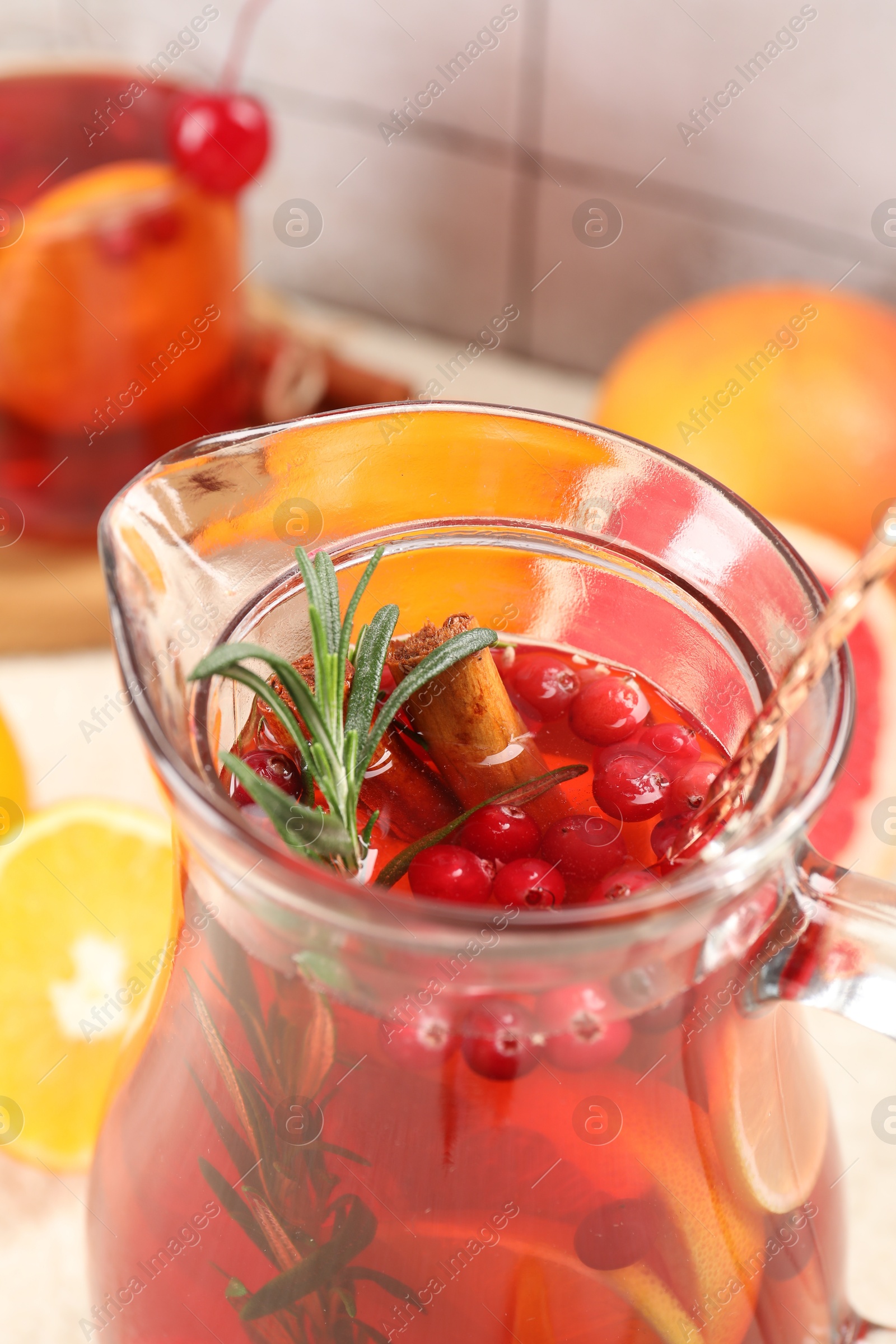 Photo of Delicious punch with rosemary in jug, closeup