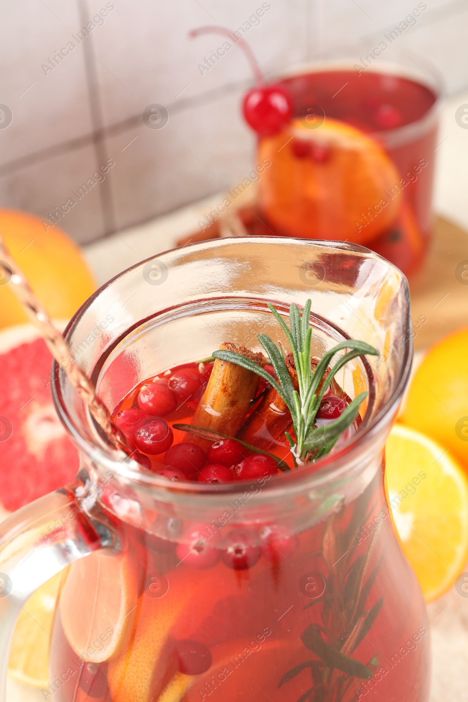 Photo of Delicious punch with rosemary in jug, closeup