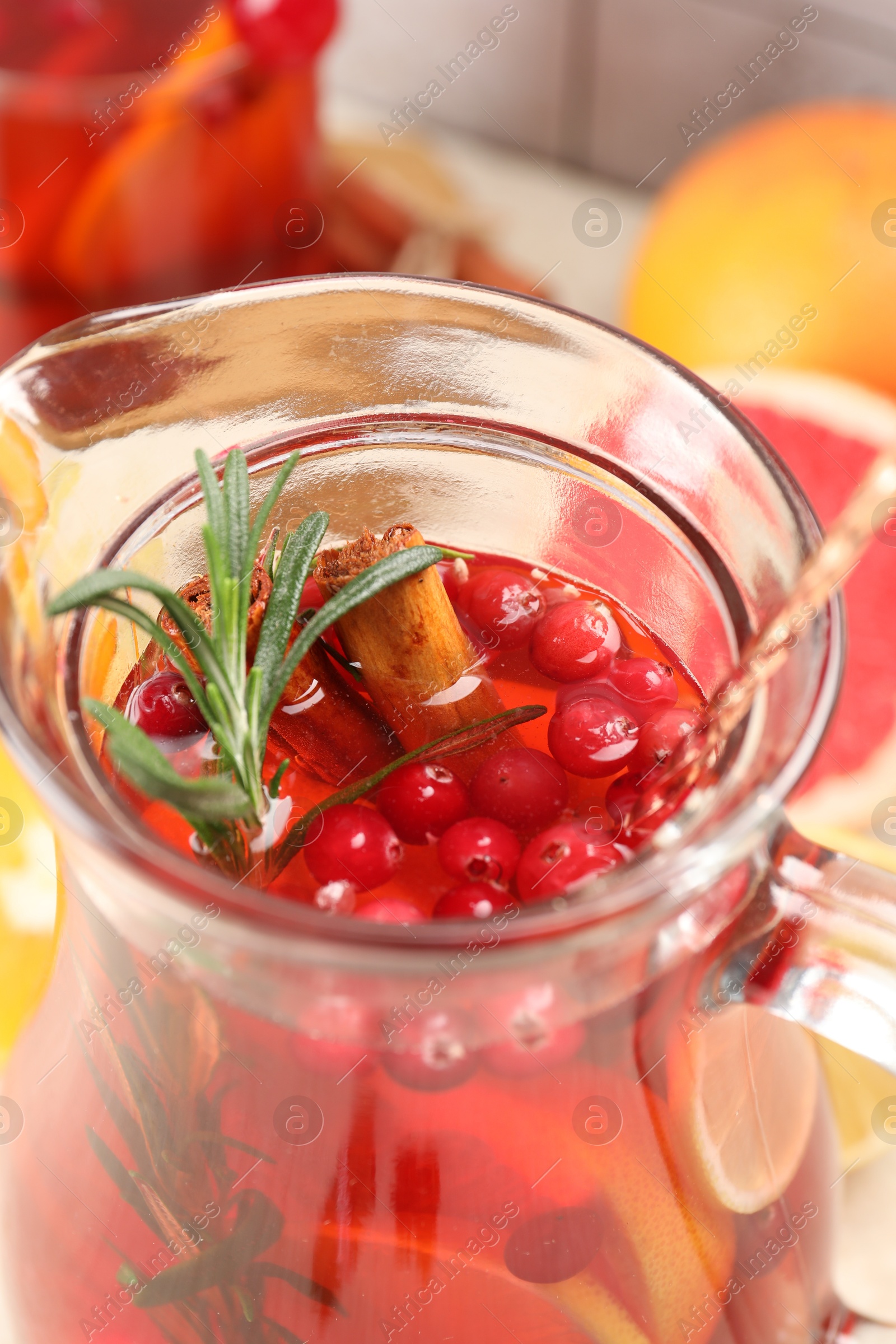 Photo of Delicious punch with rosemary in jug, closeup