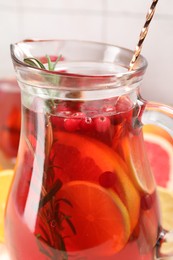 Photo of Delicious punch with rosemary in jug, closeup