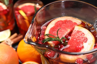 Photo of Delicious punch with rosemary in jug, closeup