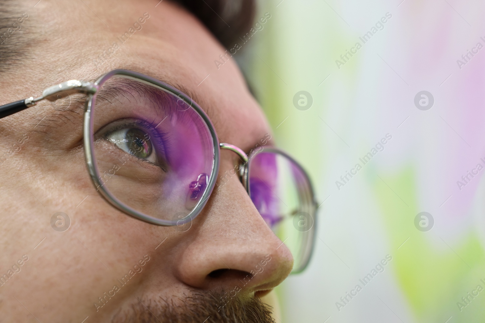 Photo of Man wearing stylish glasses on blurred background, closeup