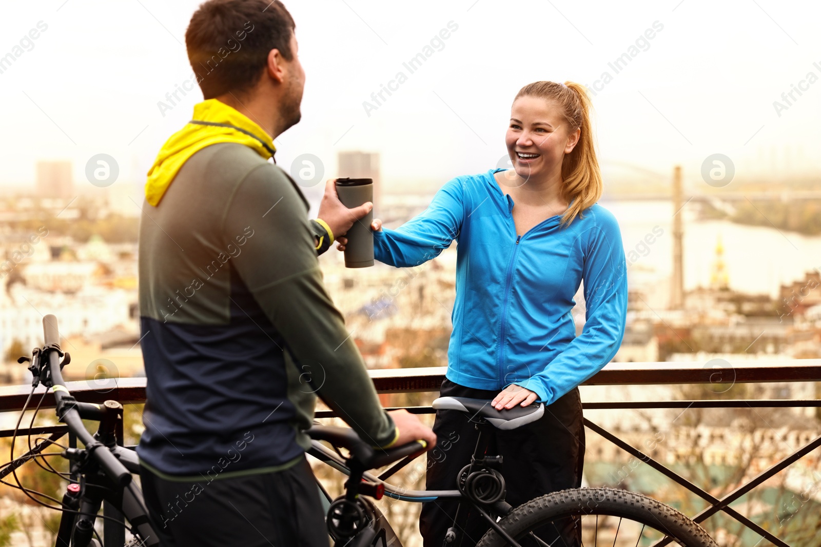 Photo of Beautiful happy couple with bicycles spending time together outdoors