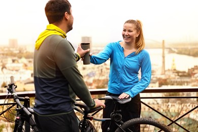 Photo of Beautiful happy couple with bicycles spending time together outdoors