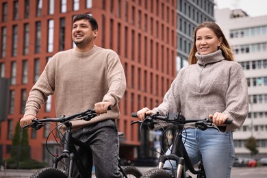 Photo of Beautiful happy couple with bicycles spending time together outdoors