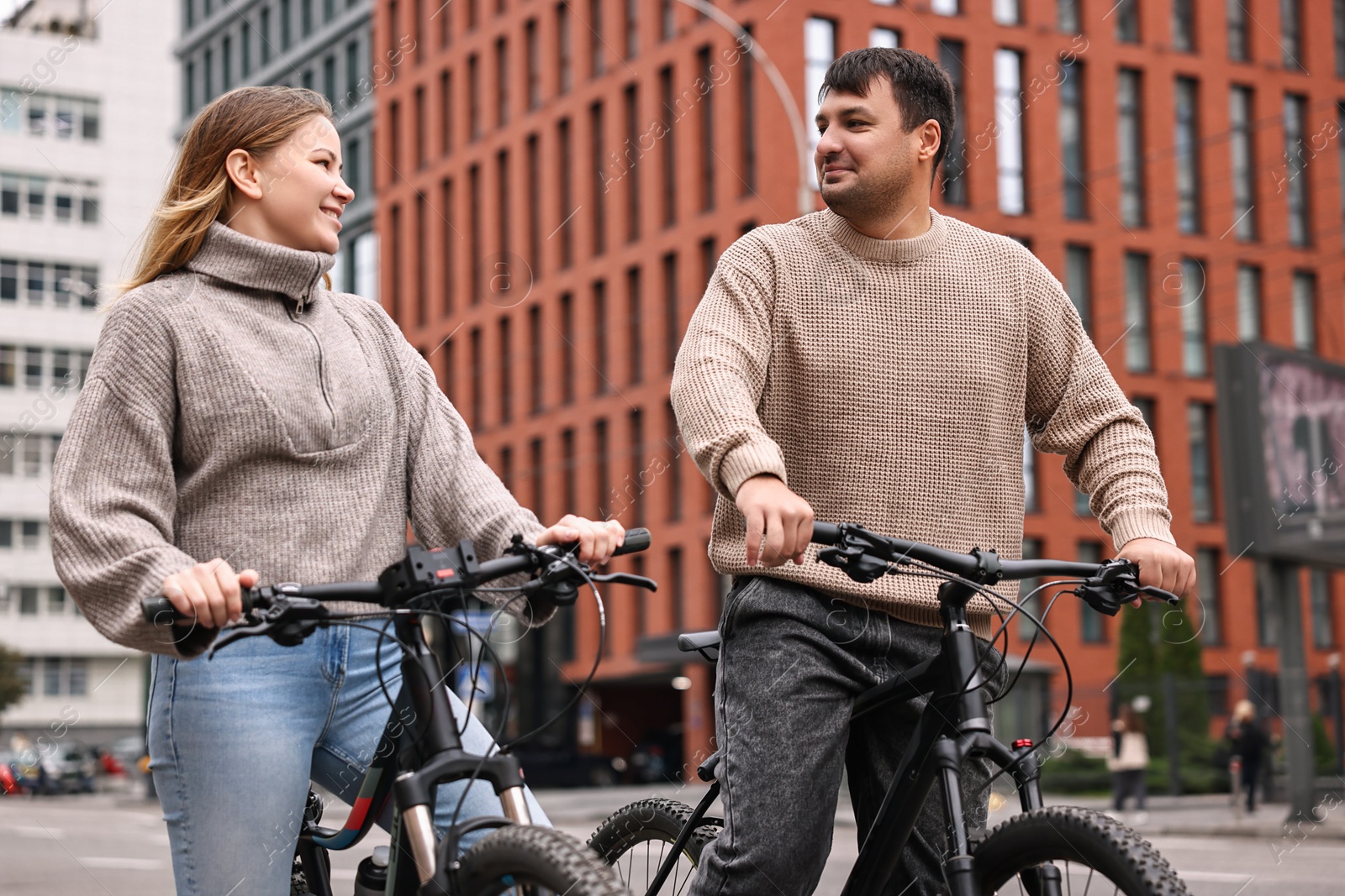 Photo of Beautiful happy couple with bicycles spending time together outdoors