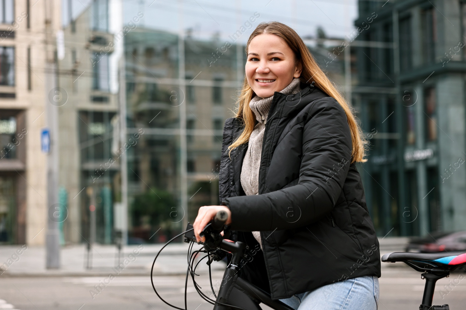 Photo of Woman with bicycle outdoors, space for text