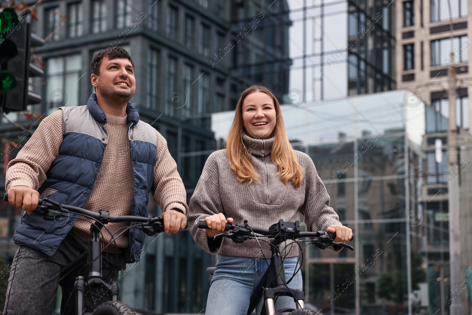 Photo of Beautiful happy couple with bicycles spending time together outdoors