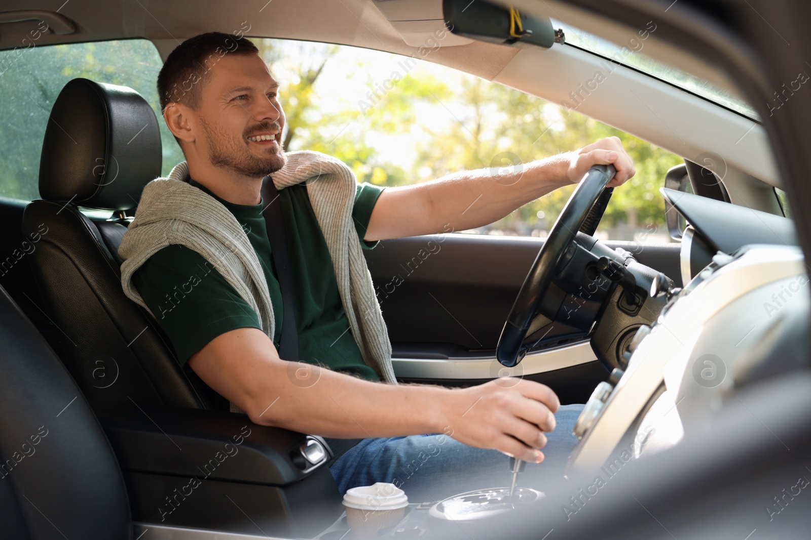 Photo of Man driving modern car, view through window