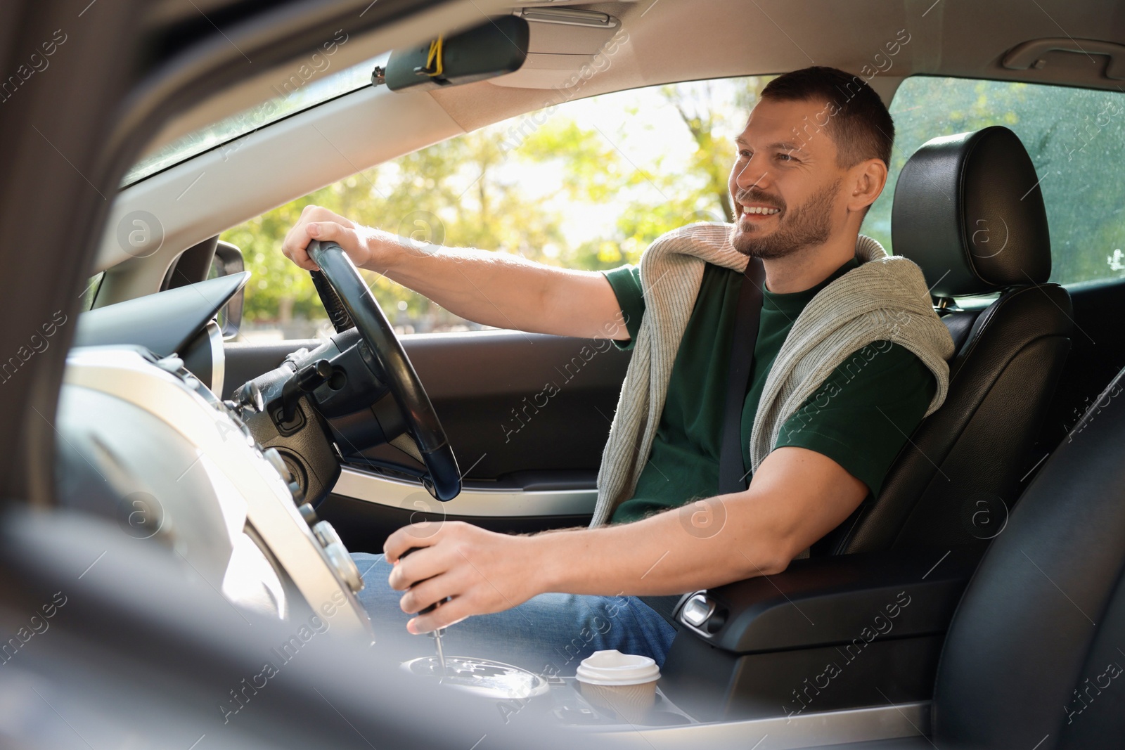 Photo of Man driving modern car, view through window