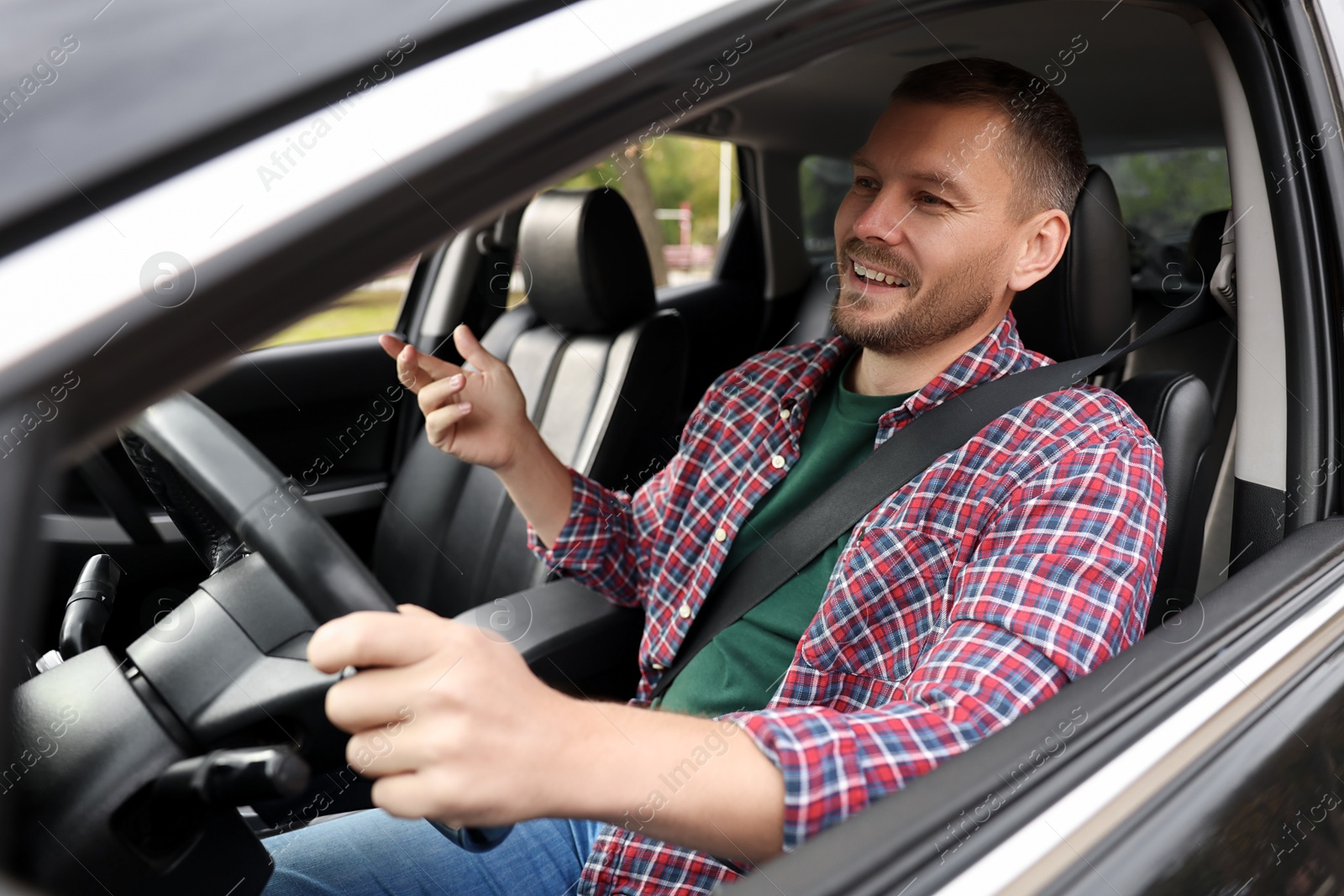 Photo of Man driving modern car, view through window