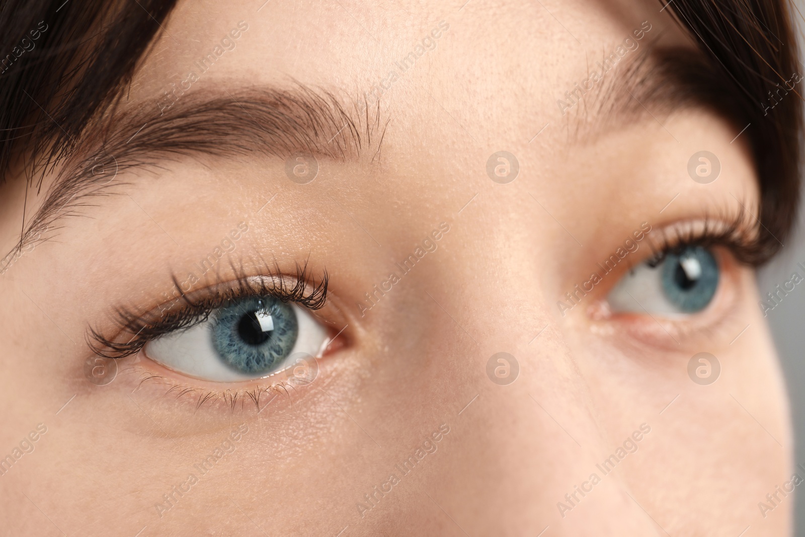 Photo of Closeup view of young woman with beautiful blue eyes