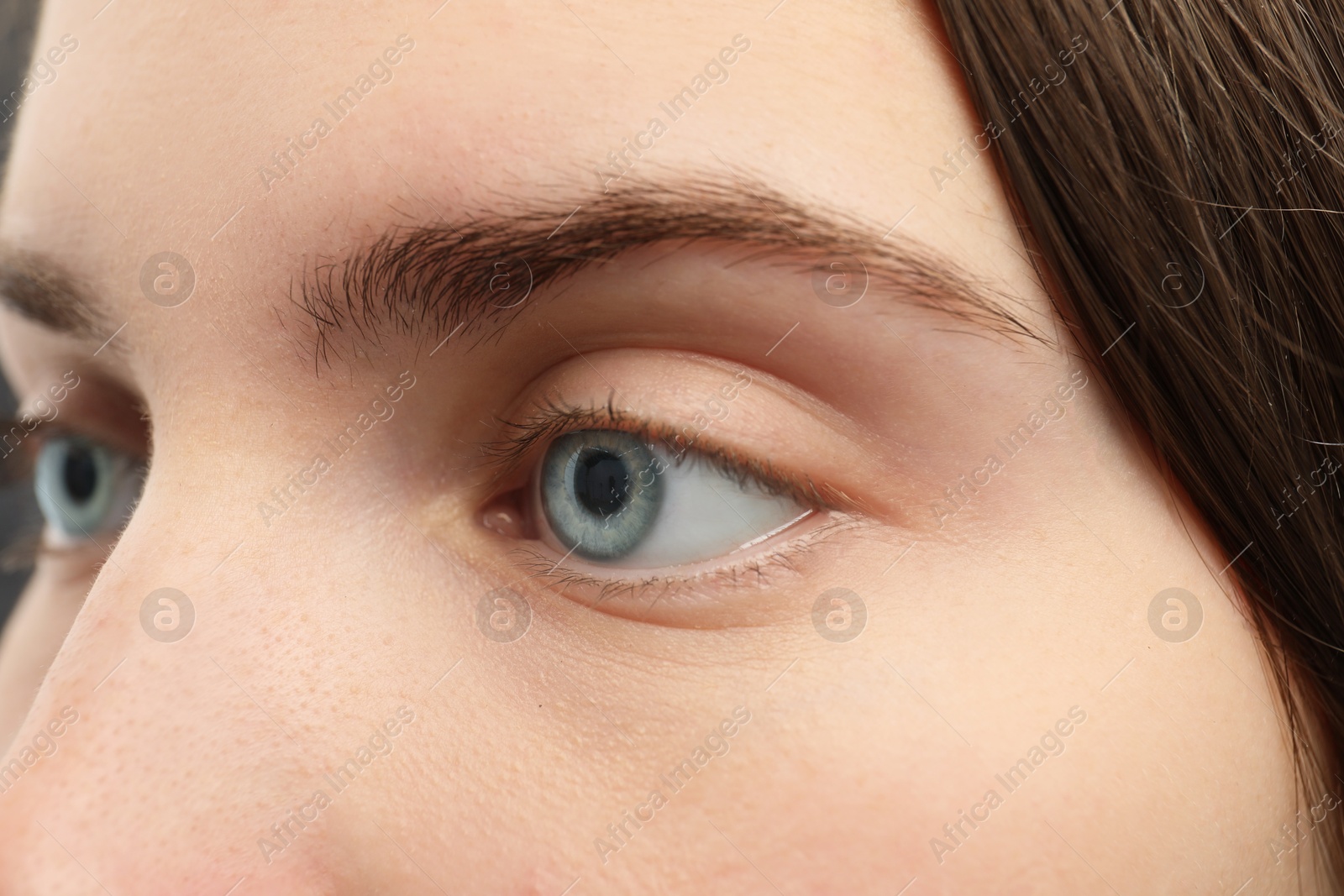 Photo of Closeup view of young woman with beautiful blue eyes