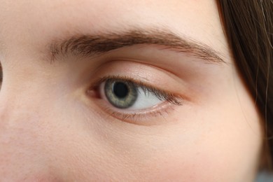 Photo of Closeup view of young woman with beautiful blue eyes