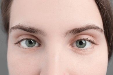 Photo of Closeup view of young woman with beautiful blue eyes