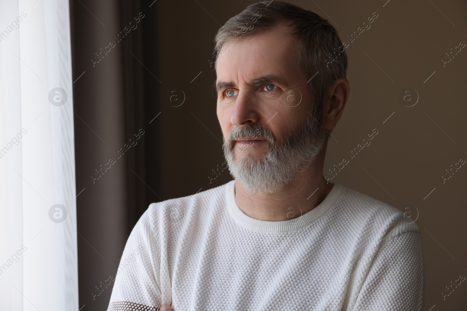 Photo of Portrait of lonely mature man at home