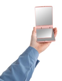 Woman holding pocket mirror on white background, closeup