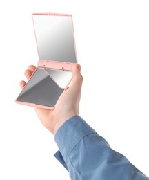 Woman holding pocket mirror on white background, closeup