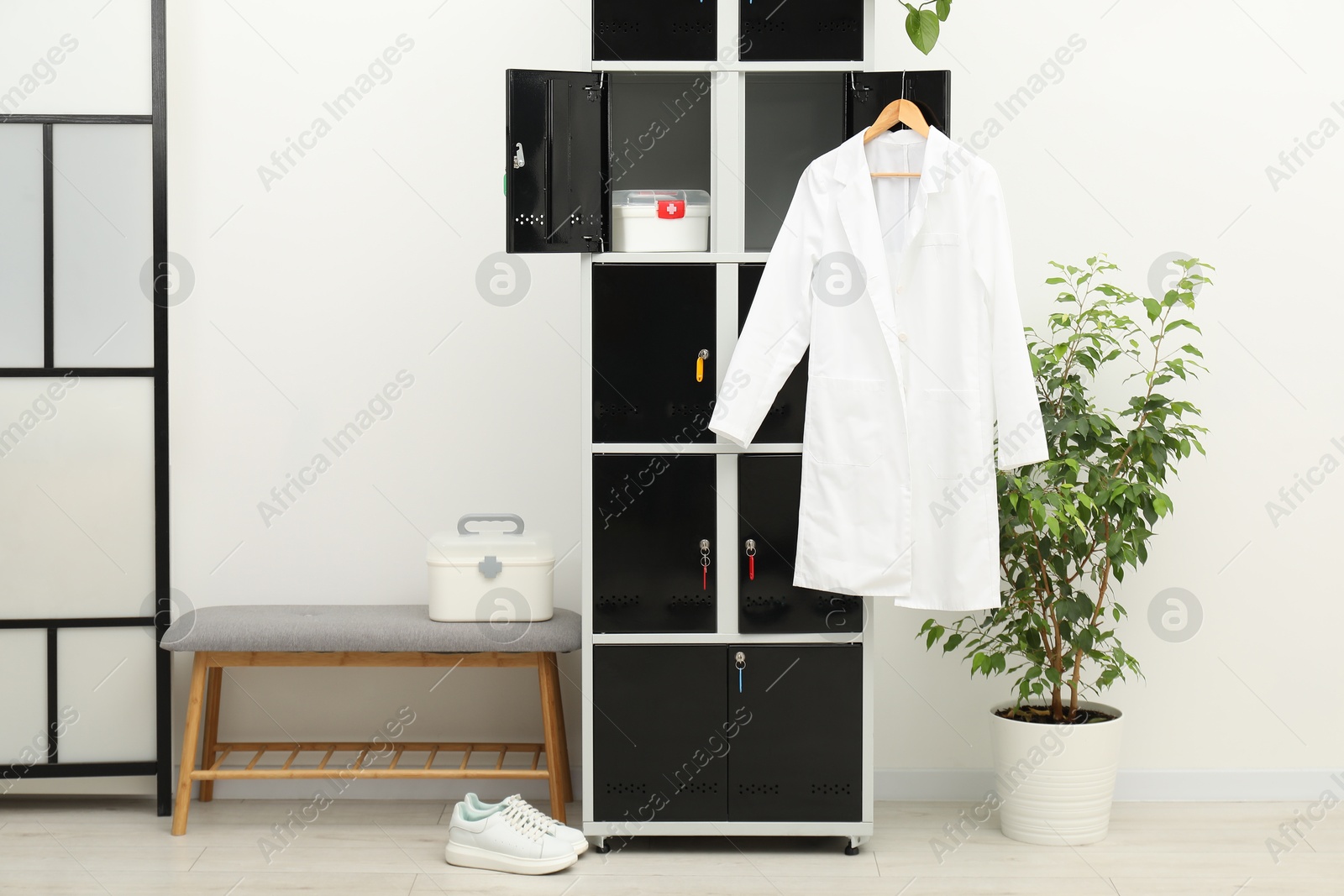 Photo of Medical personnel uniform on locker in changing room