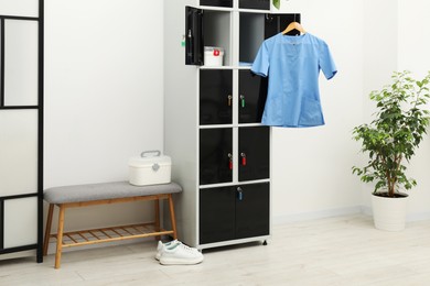 Photo of Medical personnel uniform on locker in changing room