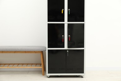 Photo of Locker with keys and bench near light wall