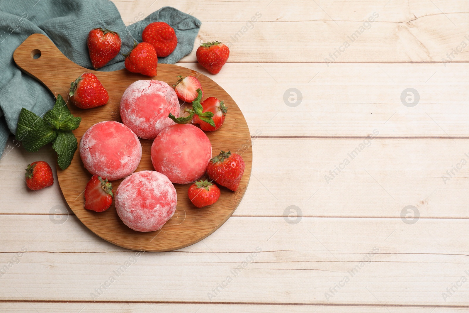 Photo of Delicious mochi, strawberries and mint on wooden table, flat lay. Space for text