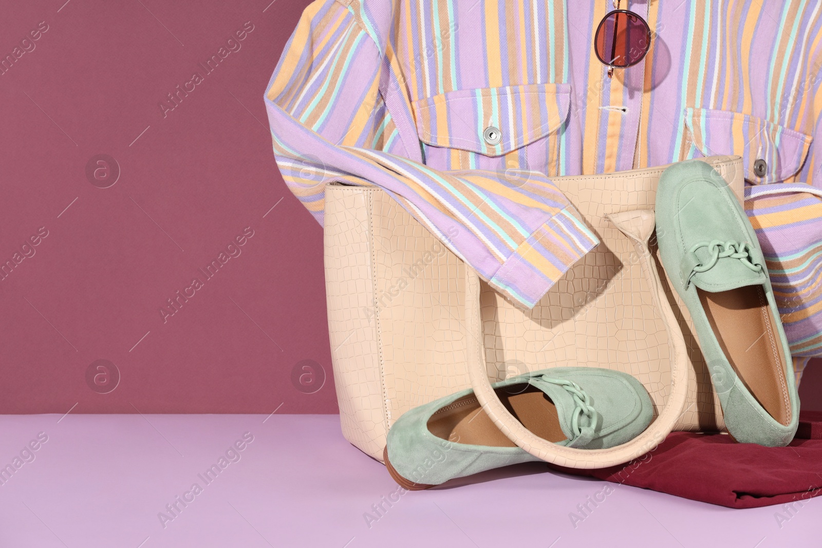 Photo of Clothes, shoes, bag and sunglasses on color background, space for text