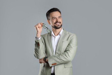 Photo of Portrait of smiling banker on grey background